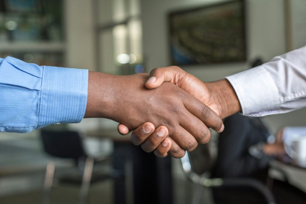 Lawyers and business professionals in a meeting discussing debt recovery strategy
