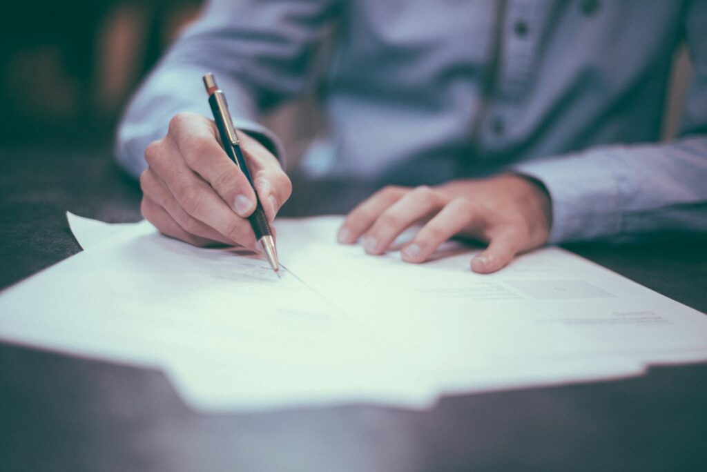 Professional reviewing licensing documents and regulatory paperwork